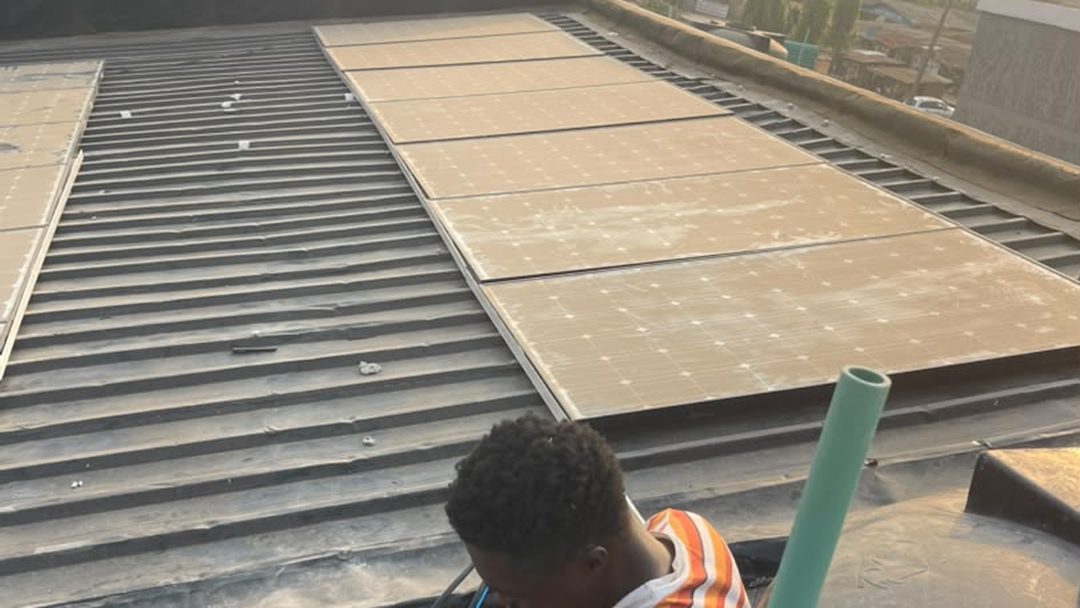 A Trewbless technician working on a rooftop solar array on a residential building.